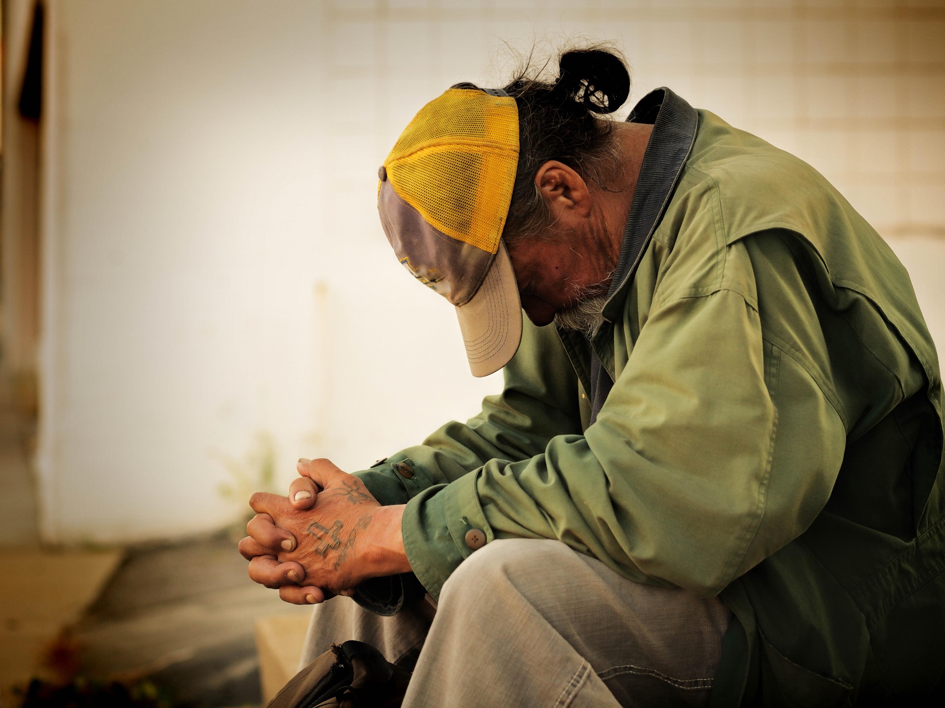 Portrait of a man affected by homelessness, seated and reflective